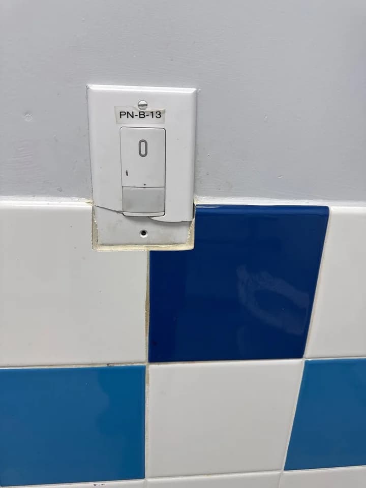 Broken restroom cover plate replaced, before