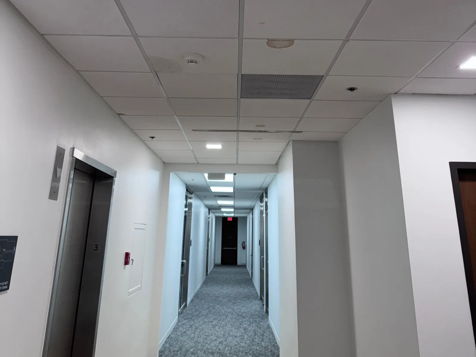 An office corridor with suite doors in a Dallas–Fort Worth building