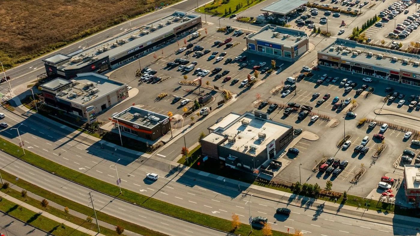 Aerial view of a retail center with several multi-tenant buildings and shared parking