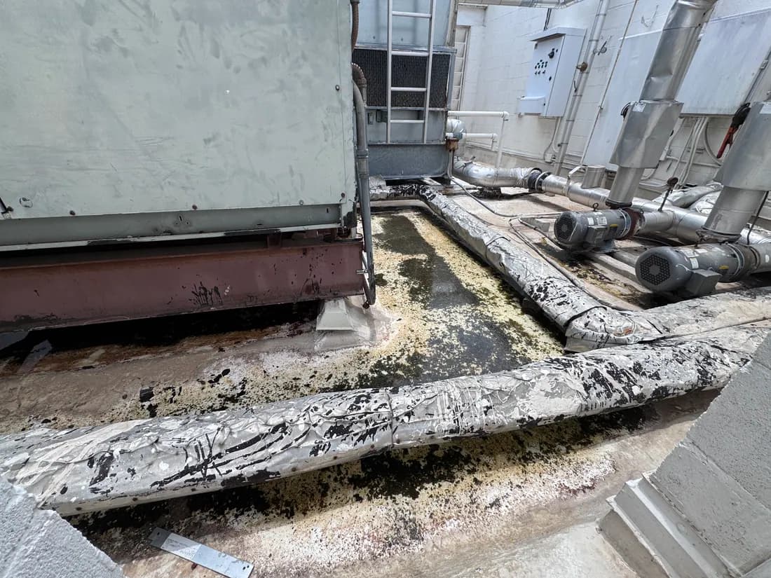 Deteriorated pipe insulation and debris at a rooftop HVAC unit