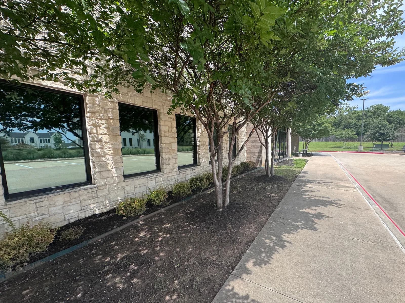Tree-lined storefront of a commercial building in Dallas–Fort Worth